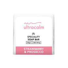 Load image into Gallery viewer, A square soap bar package from Ultracalm, labeled &quot;Ultracalm 50mg CBD Soap 100g,&quot; features a small cannabis leaf icon and is titled &quot;Specialty CBD Soap Bar.&quot; The package highlights the hydrating and nourishing scent of &quot;Strawberry &amp; Prosecco&quot; and showcases a pink and white color scheme.
